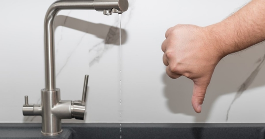 man with thumbs down to water